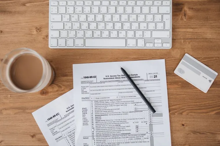 laptop with tax forms and coffee