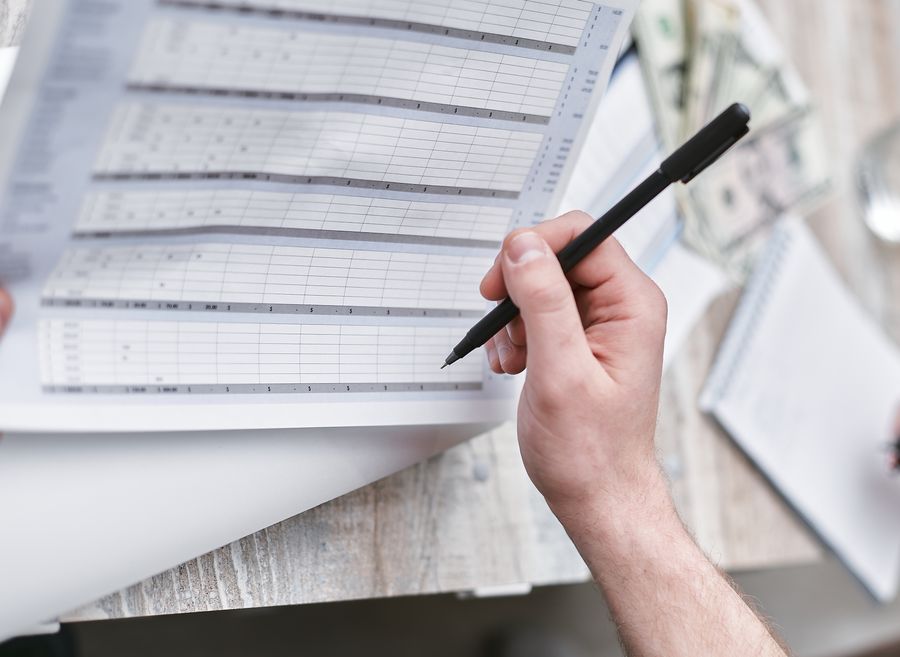 hand reviewing papers with pen